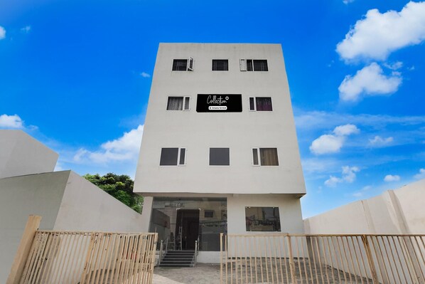 A modern building with a sign reading 'Collector & Company Services.' - Super Collection Varanasi Suites (Varanasi)