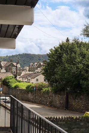 A residential area with stone walls, a metal railing, and houses with varying roof styles. - 5 Greta Side Court, Otley Road (Keswick)