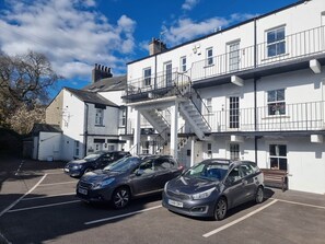 A multi-story building with a parking lot, staircases, and a balcony. - 5 Greta Side Court, Otley Road (Keswick)
