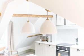 A kitchen with two pendant lights, a coffee machine, and a microwave. - Otterbield, Apartment 4, ,Derwent House (Portinscale)