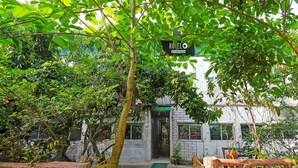 A pathway leading to a building with a sign reading 'HOUELO Company Service.' - Deluxe Ranihati Tripureswari (Howrah)