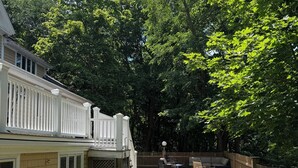 A backyard with a deck, a patio area, and a wooden fence. - BRAND NEW, Complete renovation: 4-Bedroom, 3.5 Bath, private Annisquam Gem! (Gloucester)