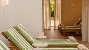 A spa area with multiple lounge chairs, a reception desk, and a view of the outdoors.