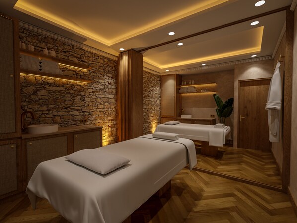 A spa room with a stone wall, wooden cabinets, a massage table, and a wooden floor. - Château du Portereau (Vertou)
