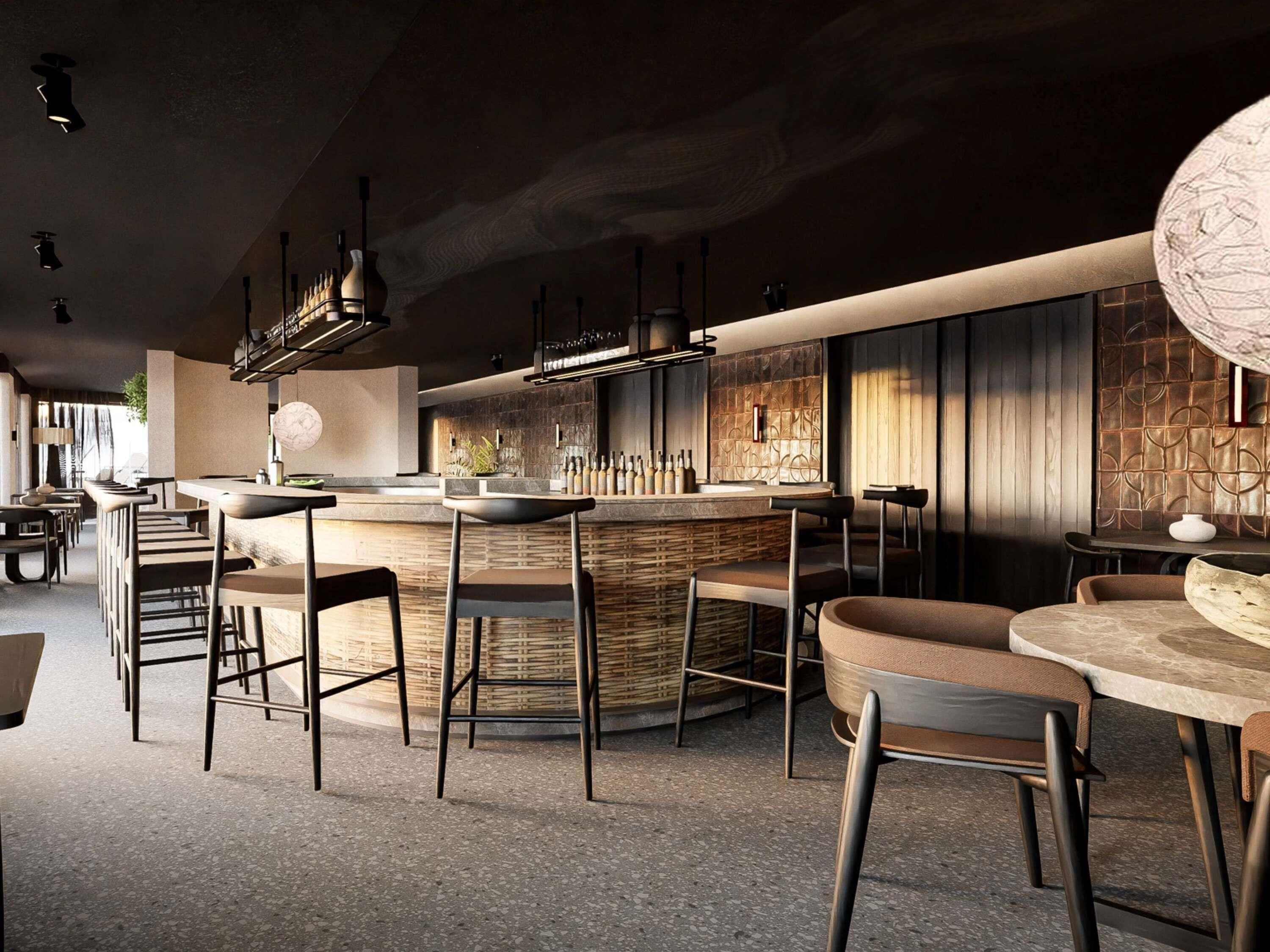 Un espace bar moderne avec un comptoir circulaire, des tabourets et un mur en pierre.