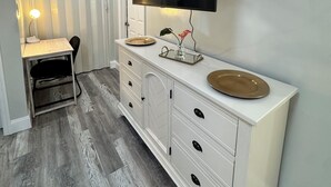 A modern bathroom with a vanity, a mirror, and a mounted TV. - Private • Peaceful Studio • Great Location (Lehigh Acres)