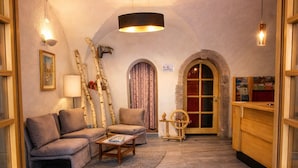 A cozy living room with a sofa, coffee table, and decorative items. - Hotel Soran (San Lorenzo Dorsino)