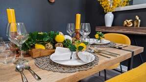 A dining table set with glassware, plates, and candles. - Stylish 2BR Corporate Stay Pool Balcony 2 (Tampa)