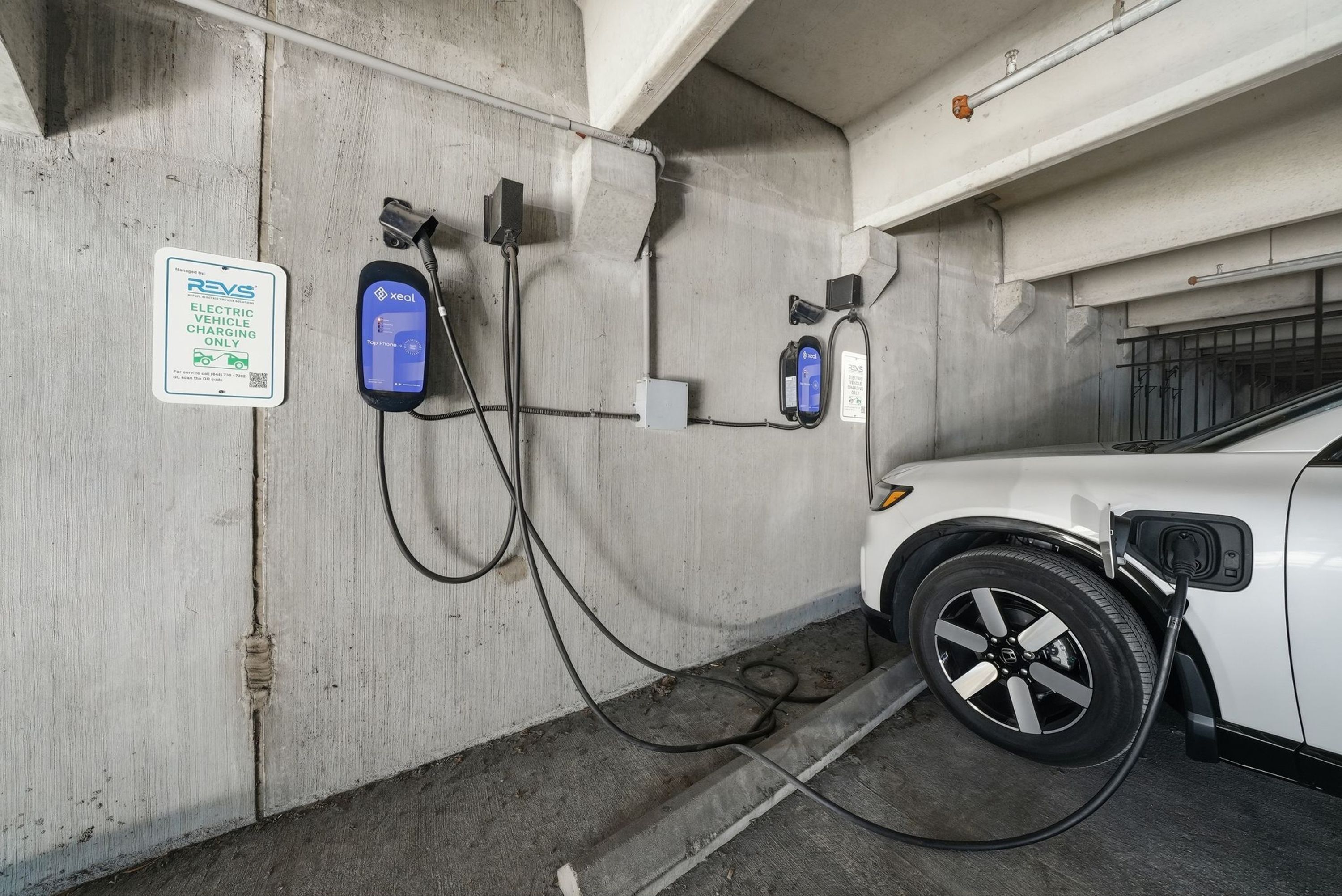 An electric vehicle charging station in a parking garage.