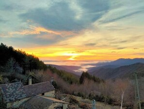 A rustic house with a sloped roof, surrounded by a forested landscape and mountains in the distance. - Nature break in the mountains (Malarce-sur-la-Thines)