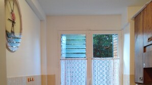 A compact kitchen with a sink, a dishwasher, and wooden cabinets. - CHATOU CITY CENTER (Chatou)