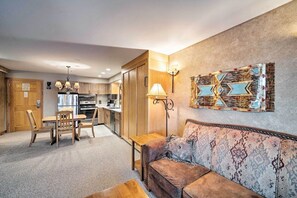 Living room featuring a sofa, dining set, and an open view into the kitchen. - Big Sky Mountain Retreat | Ski-In/Ski-Out (Big Sky)