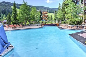 Outdoor swimming pool with lounge chairs and a mountain view. - Big Sky Mountain Retreat | Ski-In/Ski-Out (Big Sky)