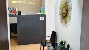 A reception desk with flags, a payment machine, and a wall-mounted mirror. - Tashkent Atlas  (Tashkent)