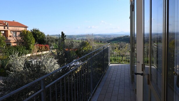 A balcony with a metal railing, a tiled floor, and a view of a distant landscape. - SE235 - Senigallia, large three-room apartment with furnished courtyard (Roncitelli)