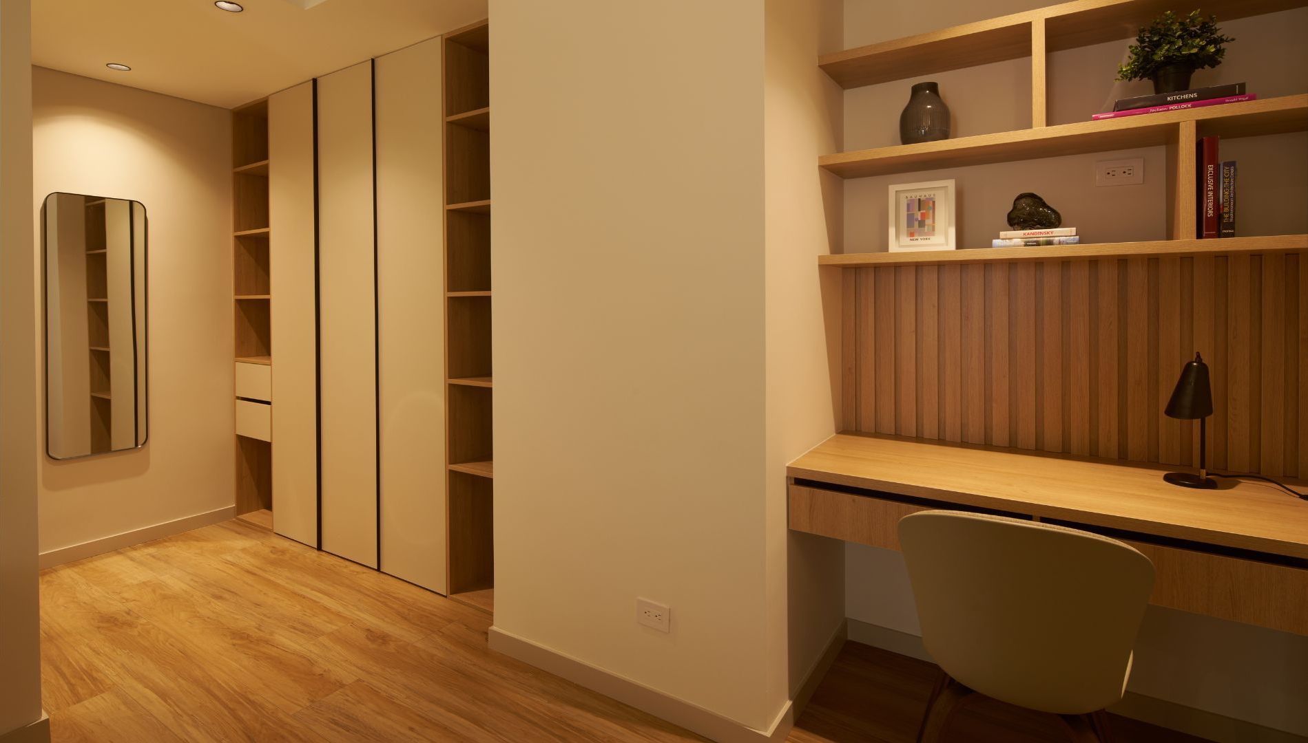 Un espace de travail moderne comprenant un bureau, une chaise et des étagères intégrées.