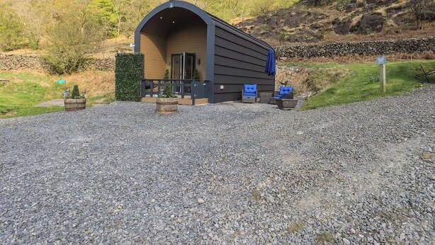 Ein kleines, einstöckiges Gebäude mit einer Veranda und Sitzbereich im Freien.