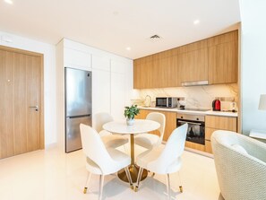 Deluxe Apartment, Balcony, Partial Sea View | Private kitchen - Stylish 1BR with Private Beach Access (Dubai)