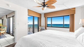 A hotel room with a large bed, a ceiling fan, a view of the ocean, and a balcony. - Emerald Towers 0605 - Gulf-front condo with private balcony and beach access in Destin (Destin)