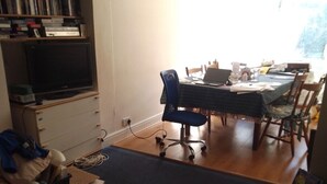 A room with a dining table, chairs, a TV, and a bookshelf. - Room-extra Large Double Room in a Shared (Worcester Park)