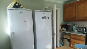 A compact kitchen with two white refrigerators, a microwave, a toaster, and wooden cabinets. - Room-extra Large Double Room in a Shared (Worcester Park)