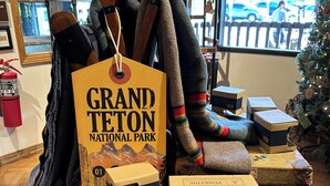 A display table with a sign reading 'GRAND TETON NATIONAL PARK' and several boxes labeled 'PENDLETON.'