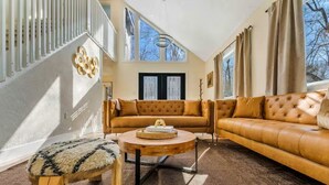 Ein Wohnzimmer mit einer Couch, einem runden Couchtisch und einer Holzbank.