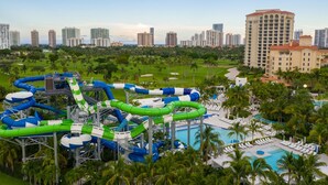 A water park with multiple slides and a pool area, surrounded by palm trees and high-rise buildings. - Cozy vacation home w/ a spacious outdoor area. Near to great beaches and casinos (Hollywood)