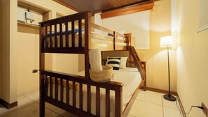 A bunk bed with a wooden headboard, a bedside table, a lamp, and a wall-mounted shelf. - CASA DARA, with a view of the Mayan Face Mountain and Lake Atitlán! (San Juan La Laguna)