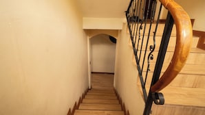 A wooden staircase with a metal handrail and a wooden banister. - CASA DARA, with a view of the Mayan Face Mountain and Lake Atitlán! (San Juan La Laguna)
