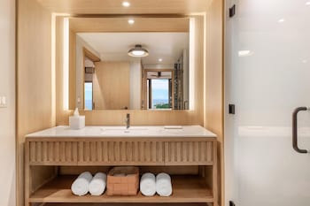A spacious gym with exercise equipment, weight racks, and a water station. at Hilton Club Ka Haku Honolulu