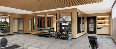 A spacious gym with exercise equipment, weight racks, and a water station.