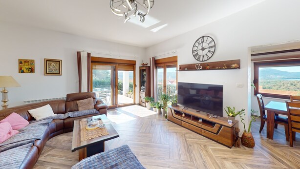 A spacious living room with a sofa, television, and a balcony with a view. - Villa in Kavac with beautiful sea view (Kavač)
