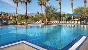 A swimming pool with palm trees, lounge chairs, and a mountain backdrop. - April 12-16th - FLASH SALE - Marriott Shadow Ridge - Full Access Resort (Palm Desert)