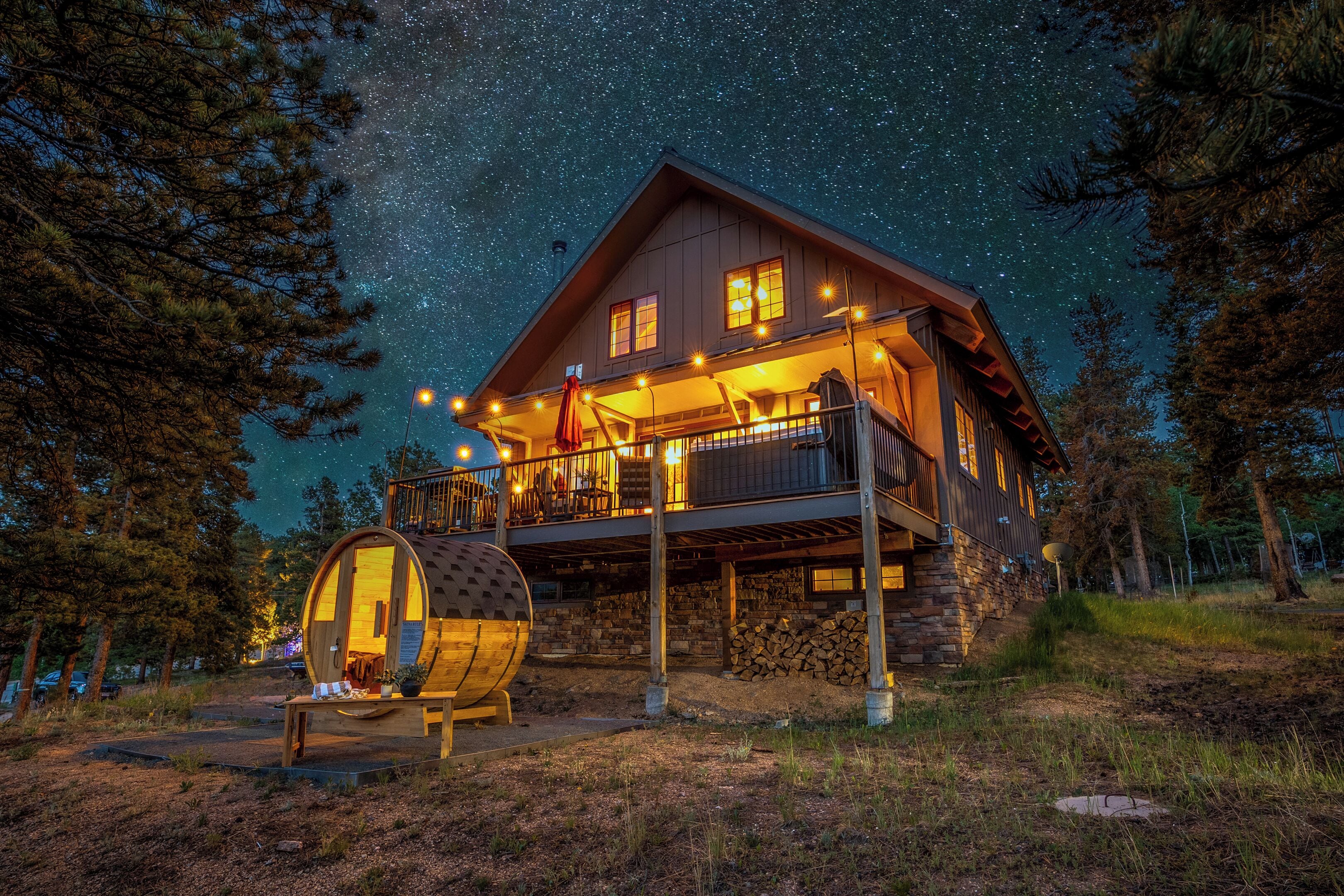 A cabin with a wooden exterior, a balcony, and a barrel.