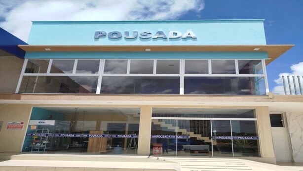 A two-story building with a sign reading 'POUSADA' above the entrance.