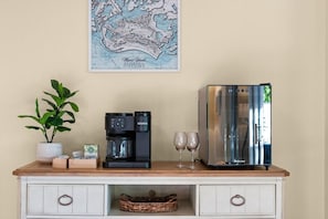A kitchenette with a coffee maker, two glasses, and a map on the wall. - Heated Pool w/ Covered Outdoor Living Near Beach (Marco Island)