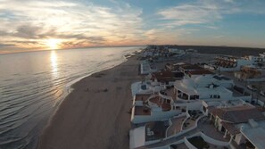 A coastal resort with beachfront villas, a sandy beach, and a sunset view. - Spacious Home in Las Conchas Villa de la Playa (Puerto Peñasco)