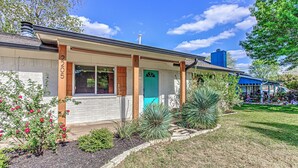 A single-story building with a front porch, a blue door, and a number '2205' on the wall. - Awake to Adventure, then Recharge and Relax in Historic Georgetown, Texas! (Georgetown)