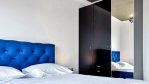 A modern bedroom with a large bed, a dark wardrobe, and a mirror. - 2 bedroom awesome apartment in Turanj (Turanj)