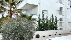 A modern building with balconies, air conditioning units, and a variety of plants. - 2 bedroom awesome apartment in Turanj (Turanj)