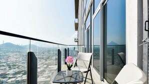A balcony with a table, chairs, and a potted plant. - Micrópolis (Monterrey)