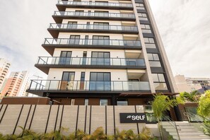 A multi-story building with balconies, a sign reading 'SELF,' and a staircase leading to the entrance. - At Self #306 - Apartment in Manaira by Carpediem (João Pessoa)