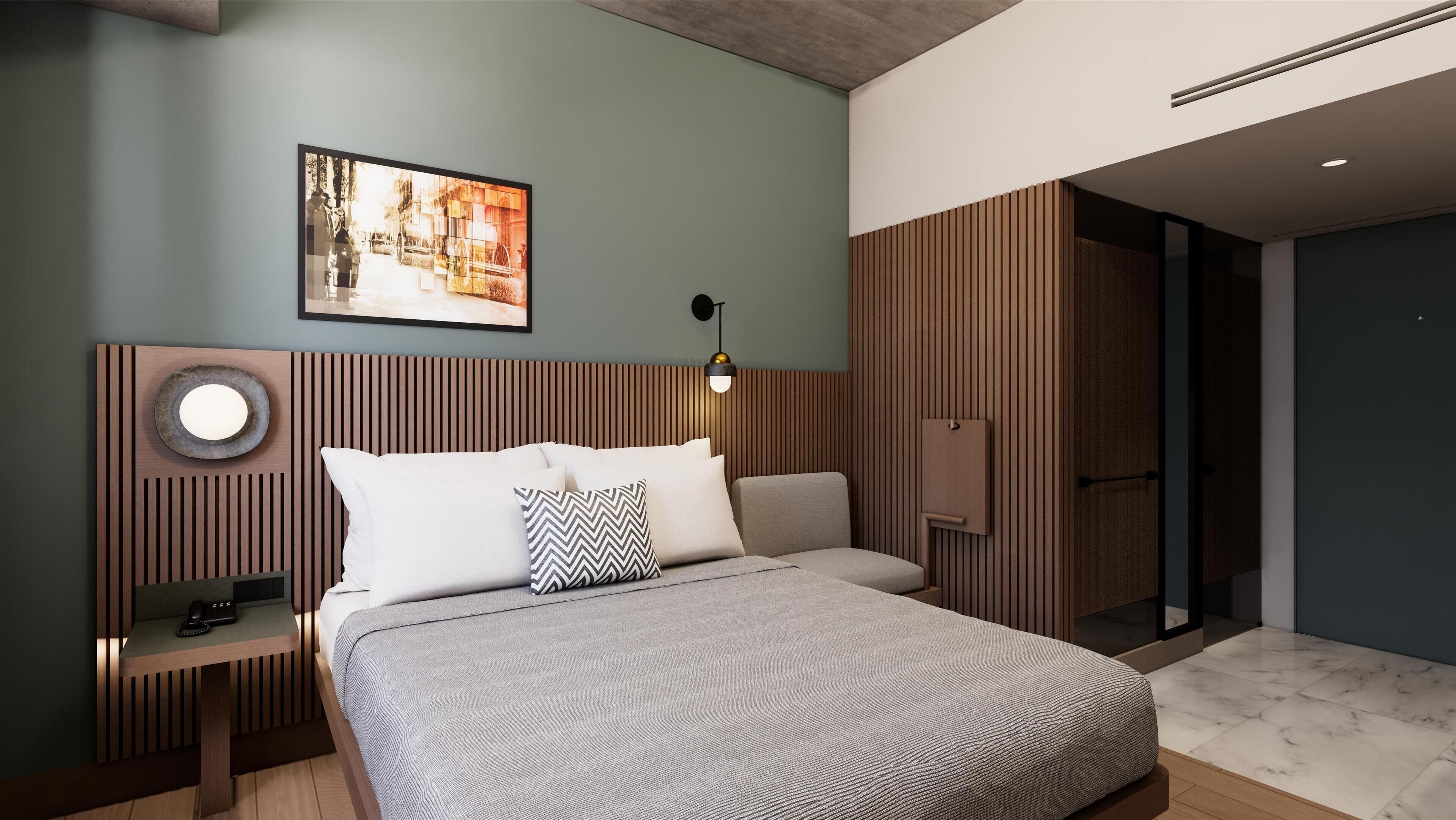 A modern bedroom with a bed, bedside table, lamp, and a framed picture on the wall.