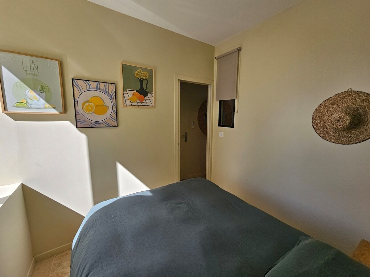 Un dormitorio con cama, puerta y decoración en la pared.