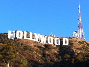 The Hollywood sign on a hill with a communication tower in the background. - 2 Connecting Suites at a  Hotel (Los Angeles)