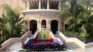 The Hollywood Hotel entrance with a fountain, steps, and palm trees.