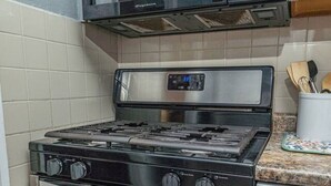 Une cuisine équipée d’une cuisinière, d’un four et d’un four à micro-ondes en acier inoxydable.