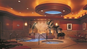 A spa area with two hot tubs, lounge chairs, and potted plants. - 1-Bedroom Suite at a 4.5⭐️ Hotel (Atlantic City)