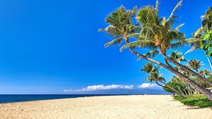 A beach with palm trees and a clear blue sky. - Kaanapali Shores | Ocean View 4 BR, Sleeps 12 | Car Incl. w/ 6+ Nights | KS ML-3762 by KBM (Lahaina)